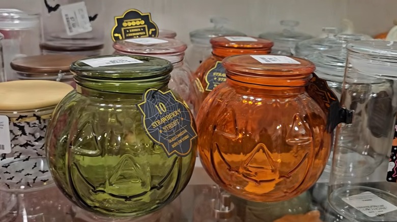 Glass jack-o'-lantern jars on store shelf