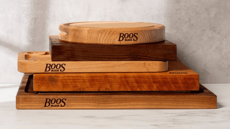 Chef cutting cheese on wooden cutting board