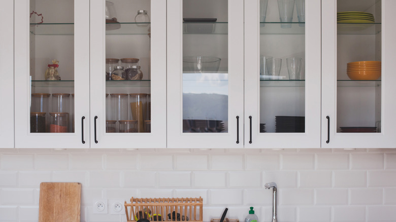 White kitchen cabinets with glass panel doors