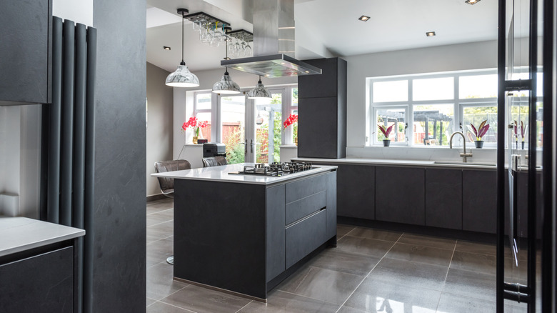 Sleek, modern kitchen with large gray tiled floor