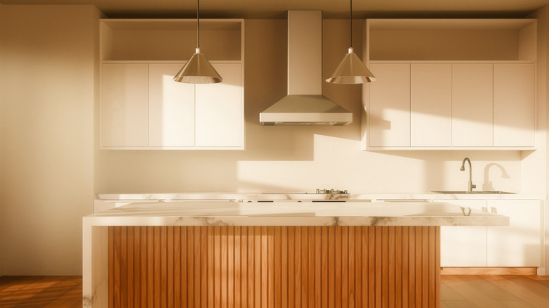 Contemporary off-white kitchen bathed in beige light