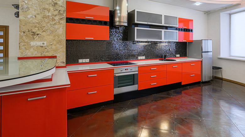 A kitchen with bright orange cabinets