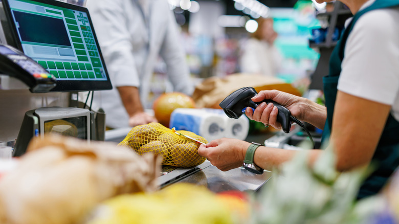 Cashier scanning potatoes