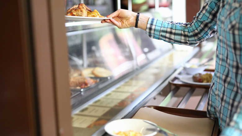 Person pushing cafeteria tray