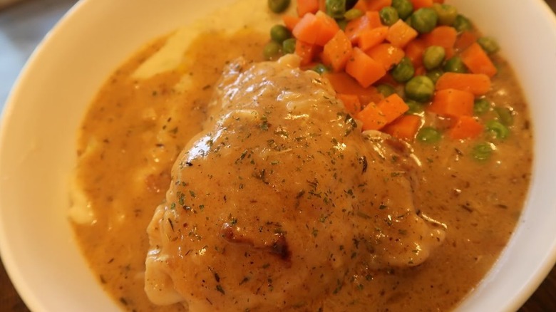Plate of smothered chicken and vegetables