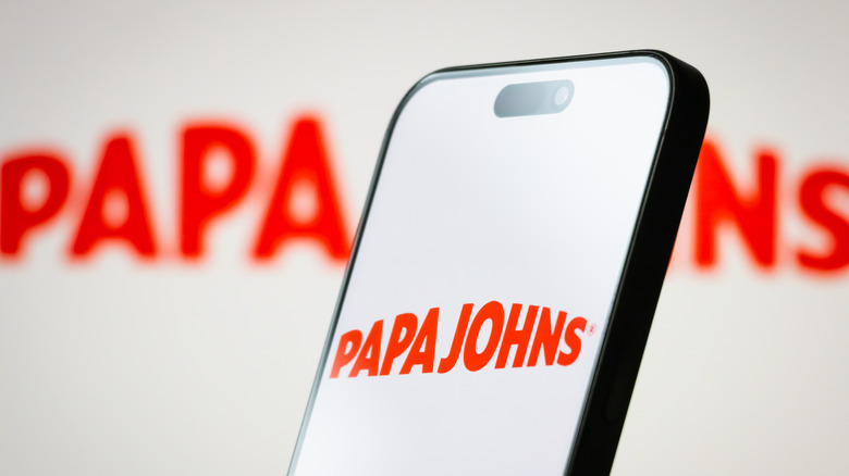 A smartphone with the Papa Johns logo on the screen