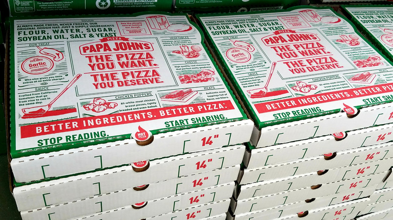 Large stacks of Papa Johns pizza boxes