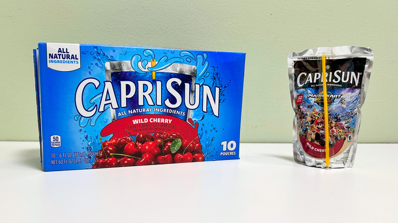 A box of Capri Sun Wild Cherry next to a pouch of Wild Cherry juice