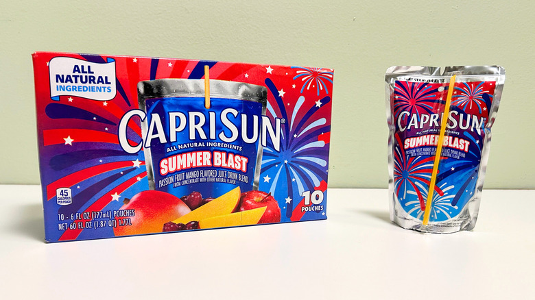 A box of Capri Sun Summer Blast next to a Summer Blast juice pouch