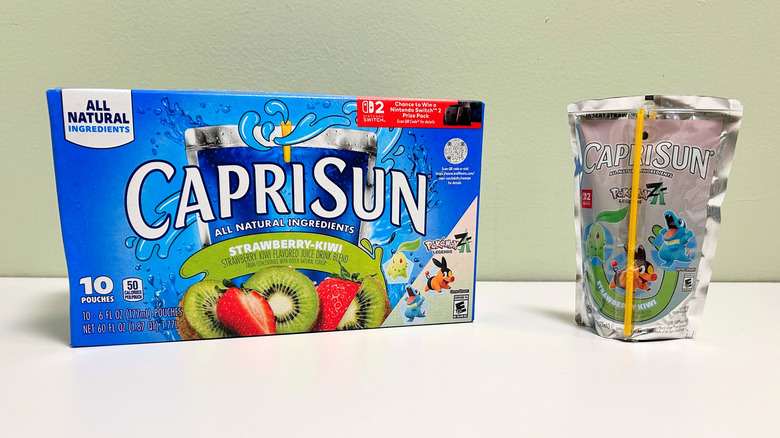 A box of Capri Sun Strawberry Kiwi next to a pouch of strawberry kiwi juice