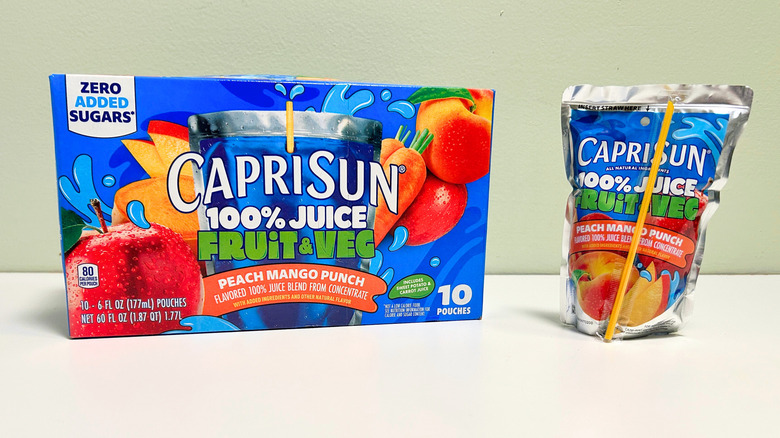 A box of Capri Sun Fruit and Veg Peach Mango Punch next to a pouch of peach mango punch