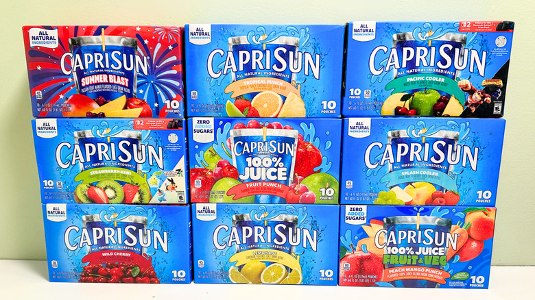 Nine boxes of Capri Sun juice pouches stacked together in three rows