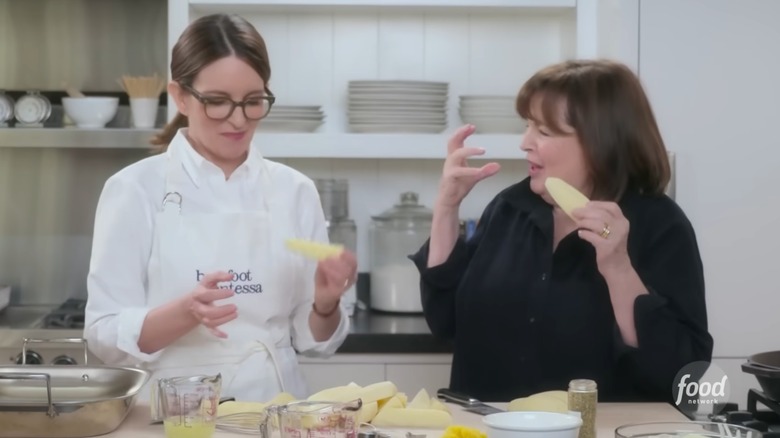 A still from "Be My Guest With Ina Garten," which shows Tina Fey and Ina Garten cooking