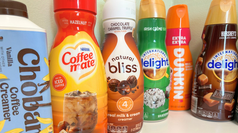 Close up of several popular coffee creamers in a staggered row