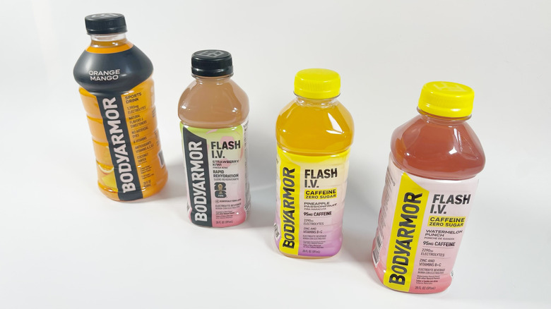 Four bottles of Body Armor and Body Armor Flash I.V. on a white background