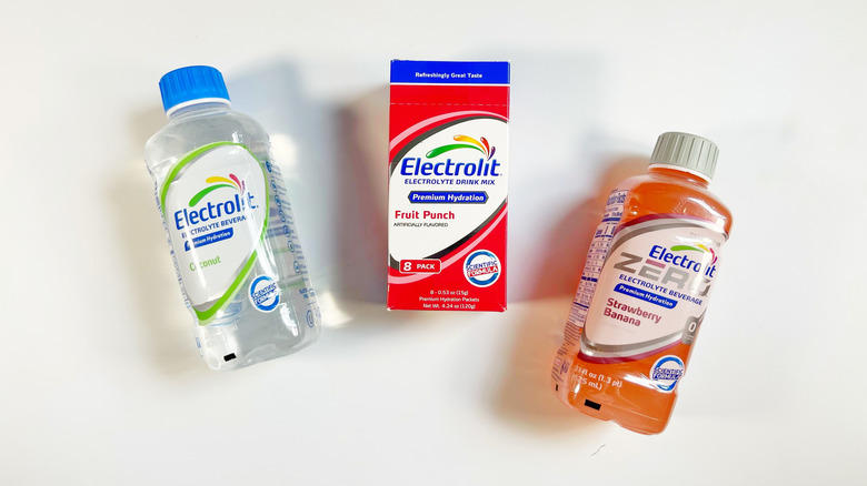Two Electrolit bottles and a box of powder sticks on a white background