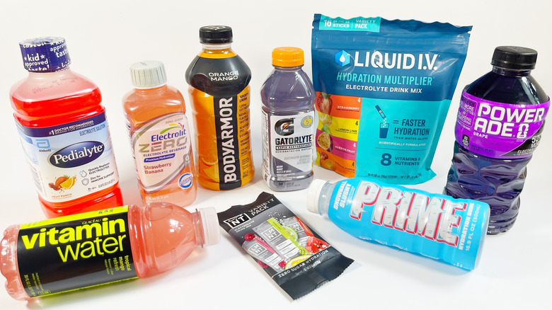 Several different colorful bottles and bags of electrolytes and sports drinks