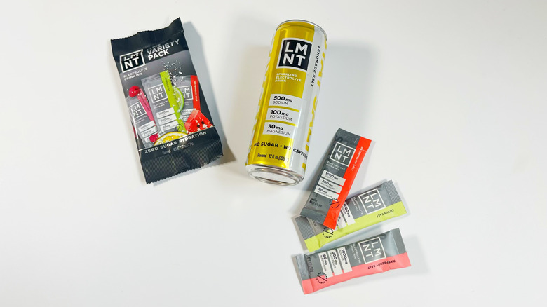 A few powder sticks and a can of LMNT on a white background