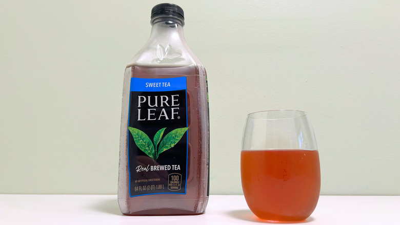 A bottle of Pure Leaf Sweet Tea next to a glass of sweet tea
