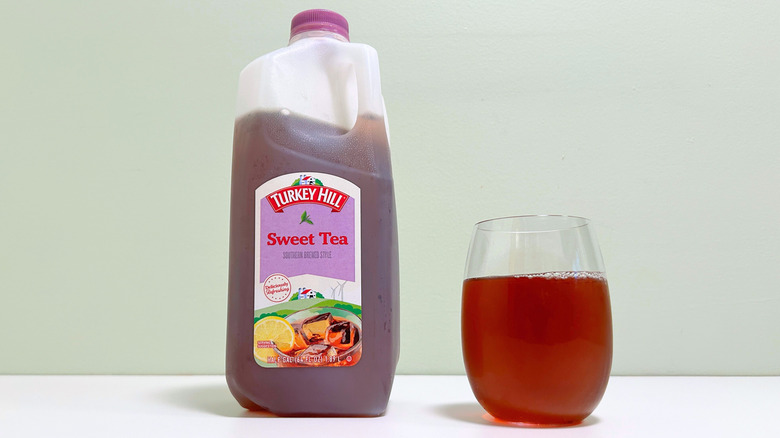 A jug of Turkey Hill Sweet Tea next to a glass of sweet tea