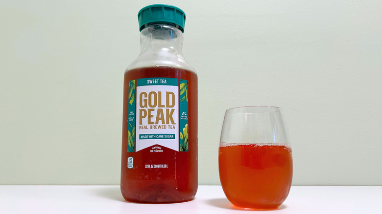 A bottle of Gold Peak Sweet Tea next to a glass of sweet tea