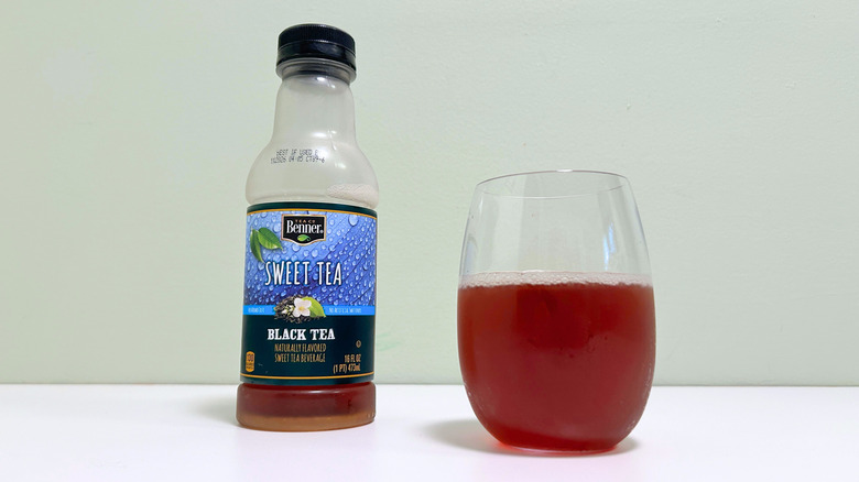 A bottle of Benner Sweet Tea next to a glass of sweet tea