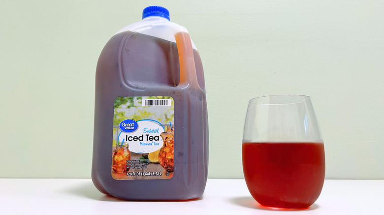 A jug of Great Value Sweet Iced Tea next to a glass of sweet tea