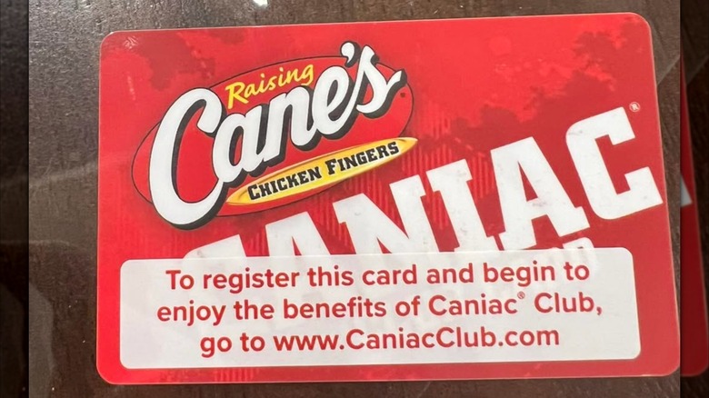 A Caniac Club membership card, displaying its registration instructions on the front
