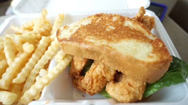 A Raising Cane's chicken sandwich made with Texas toast instead of the regular bun, with a side of fries