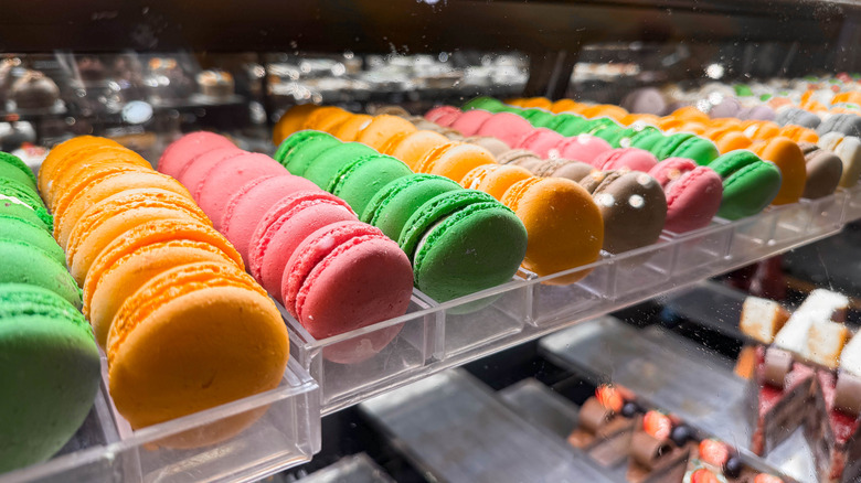 Different types of macarons arranged inside a display case