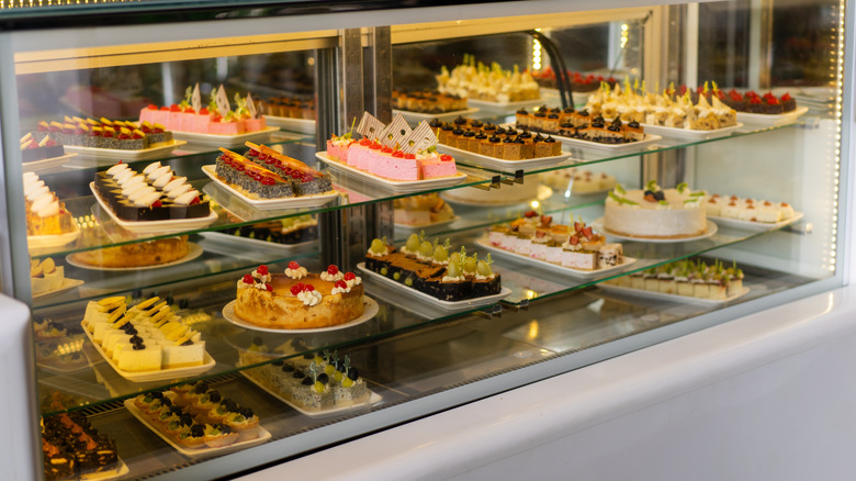 Various pastries and cakes arranged inside a display case