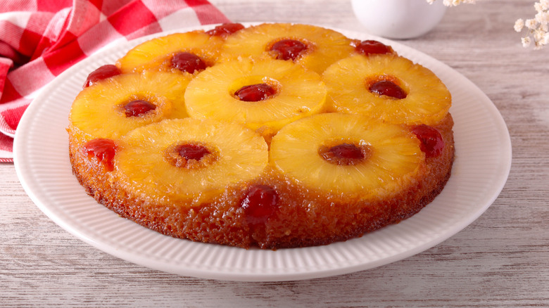 A pineapple upside-down cake on a white plate