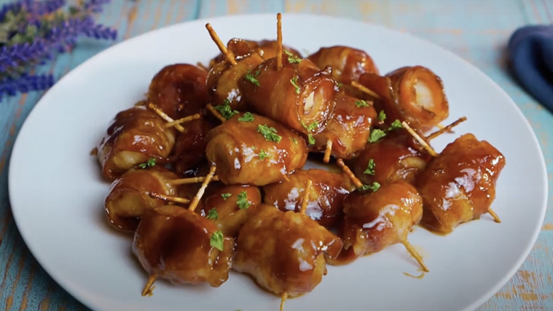 A plate of rumaki, glazed with sauce