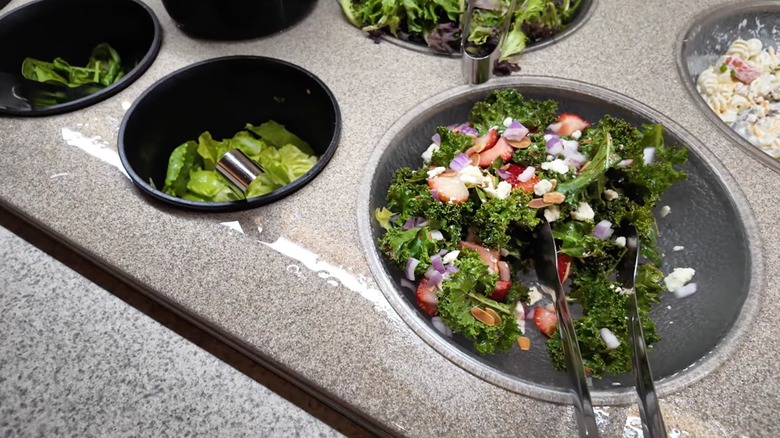 Various salads and salad items are seen at a Hoss's Steakhouse salad bar
