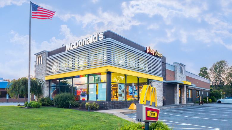 Exterior of McDonald's restaurant with an American flag in front
