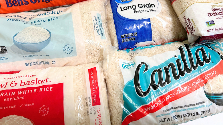 Extreme close-up of several store-bought white rice brands arranged together