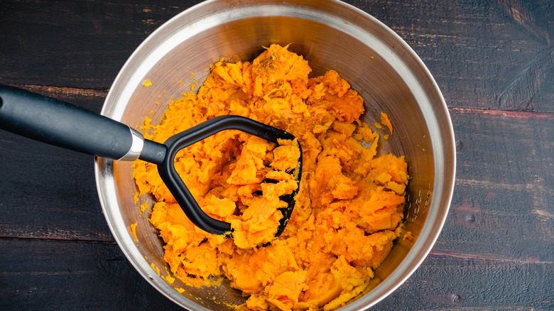 mashing sweet potatoes