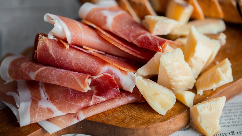 wooden board with cheese and ham