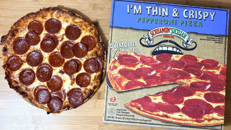 cooked screamin sicilian pepperoni pizza on left and boxed pizza on right