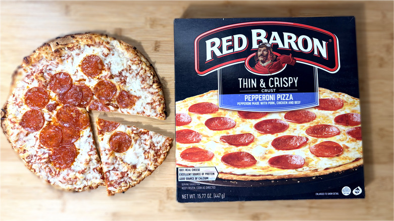 cooked red baron pepperoni pizza on left and boxed pizza on right