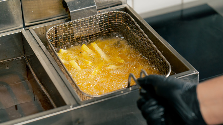 Fries are cooked in a restaurant deep fryer