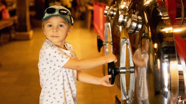 A child in front of a beer fermenter