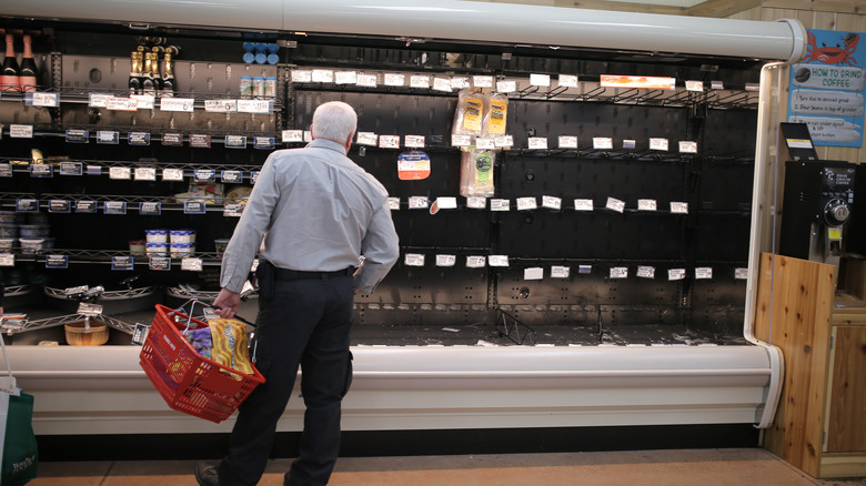 Customer looking at empty shelves