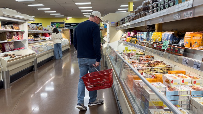 Customer shopping frozen foods section of Trader Joe's