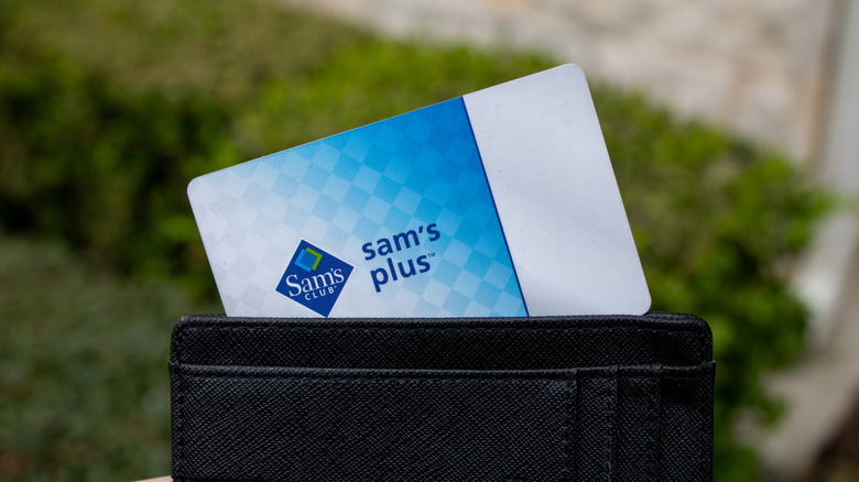 A Sam's Club Plus Membership card sticks out of a wallet