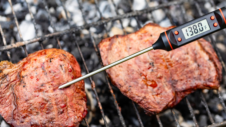 Meat on the grill with thermometer