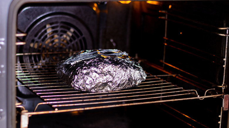 Meat wrapped in foil in the oven