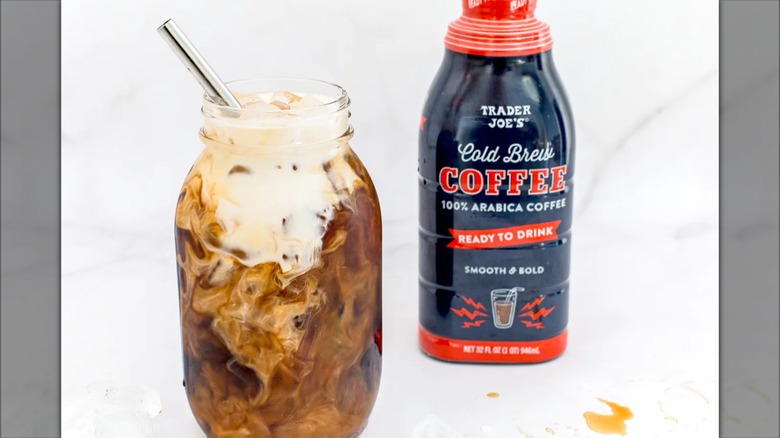 A container of Trader Joe's Ready to Drink Cold Brew Coffee, next to a jar of it with milk