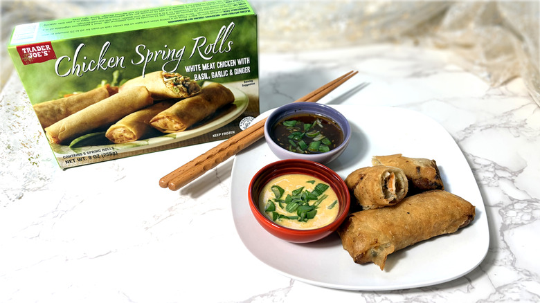 package and plate of chicken spring rolls with chopsticks and dipping sauces