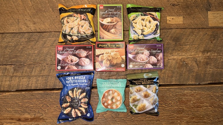 An assortment of Trader Joe's frozen dumplings on a wooden table